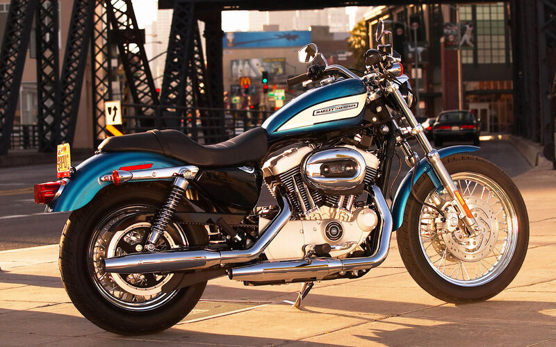 Blue Harley-Davidson motorcycle on city street