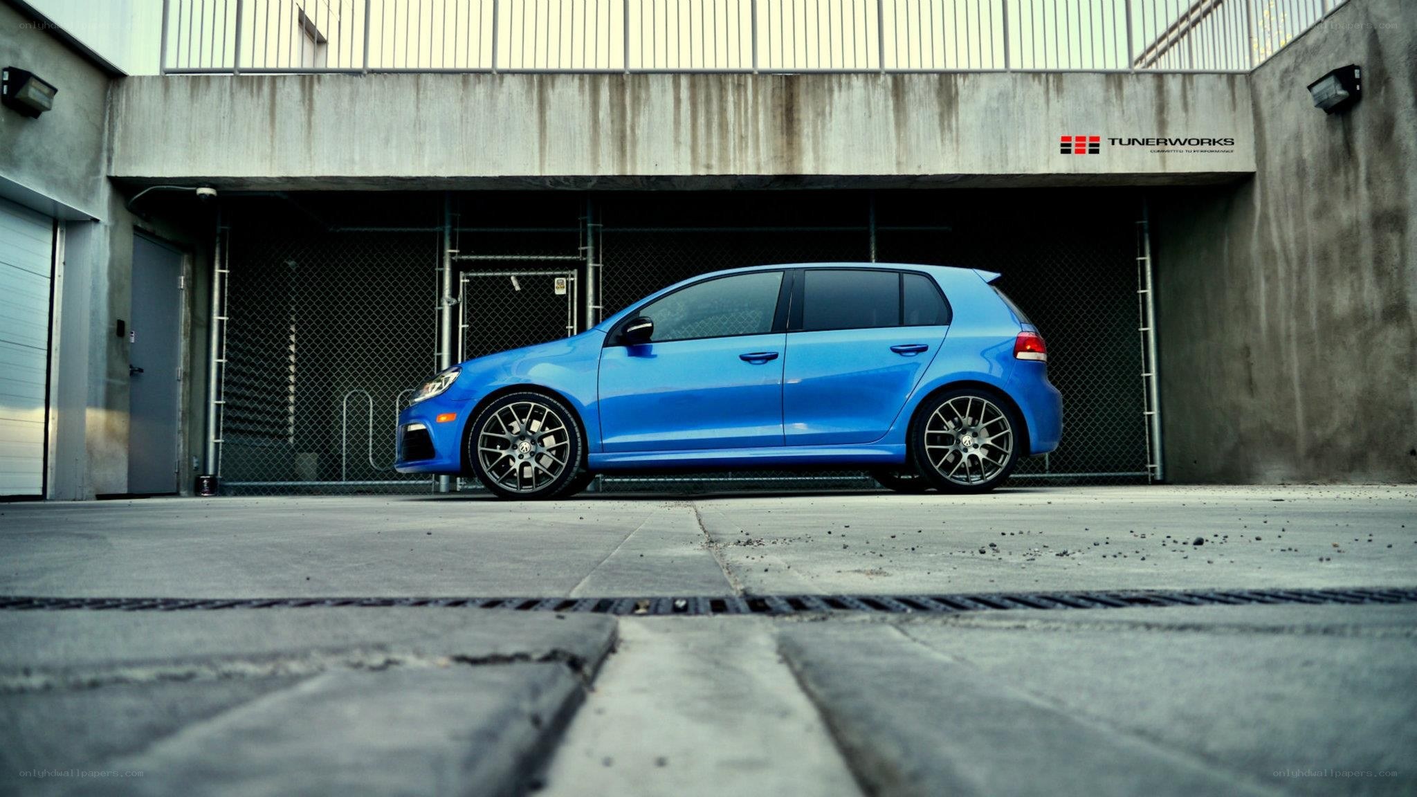 blue hatchback car in garage