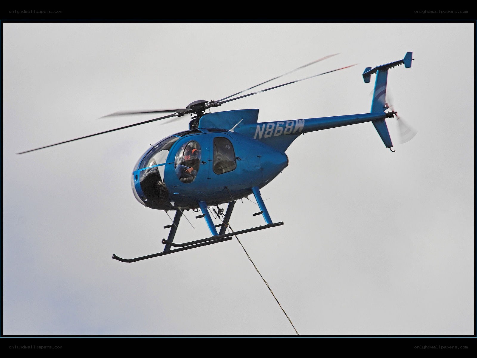 Blue helicopter in flight