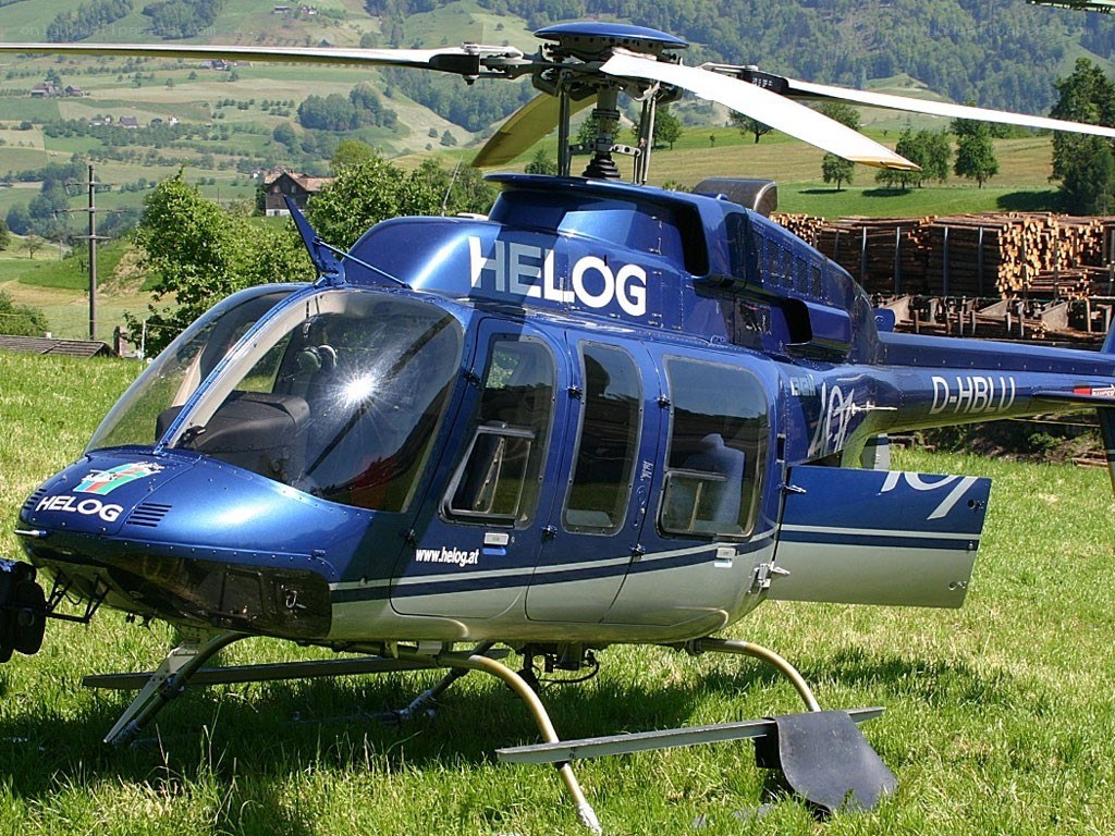 Blue helicopter on a grassy field