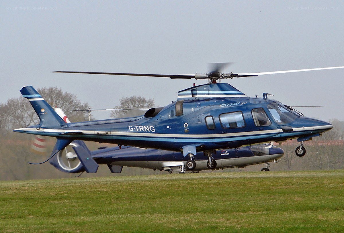 Blue helicopter on grass field