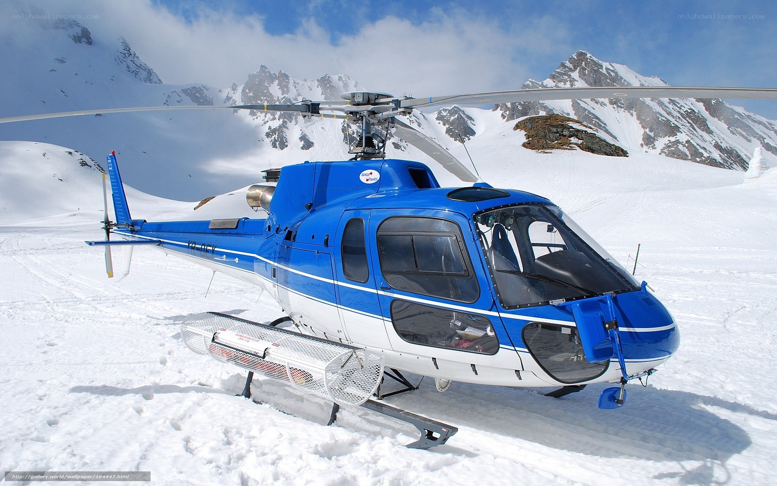 Blue helicopter on snowy mountain
