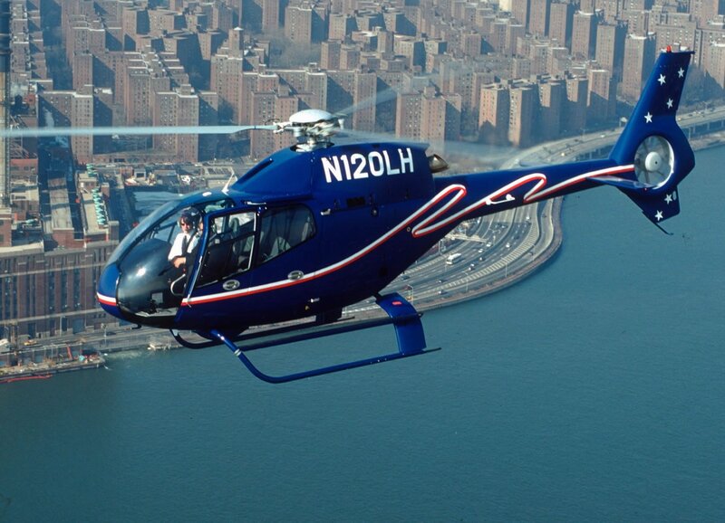 Blue helicopter over city