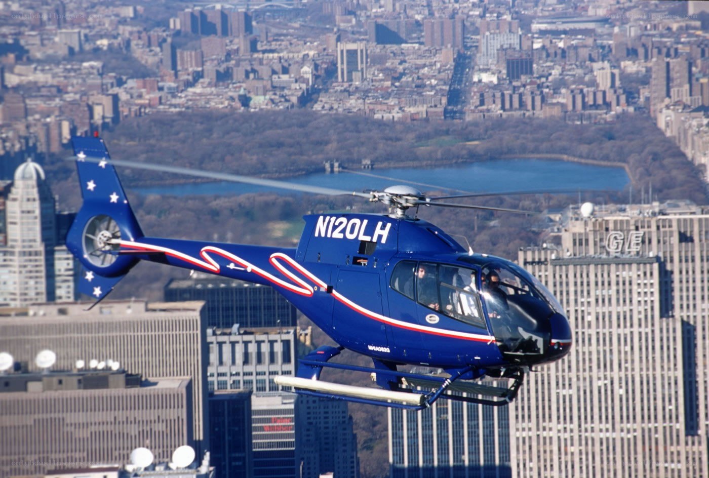 Blue helicopter over city