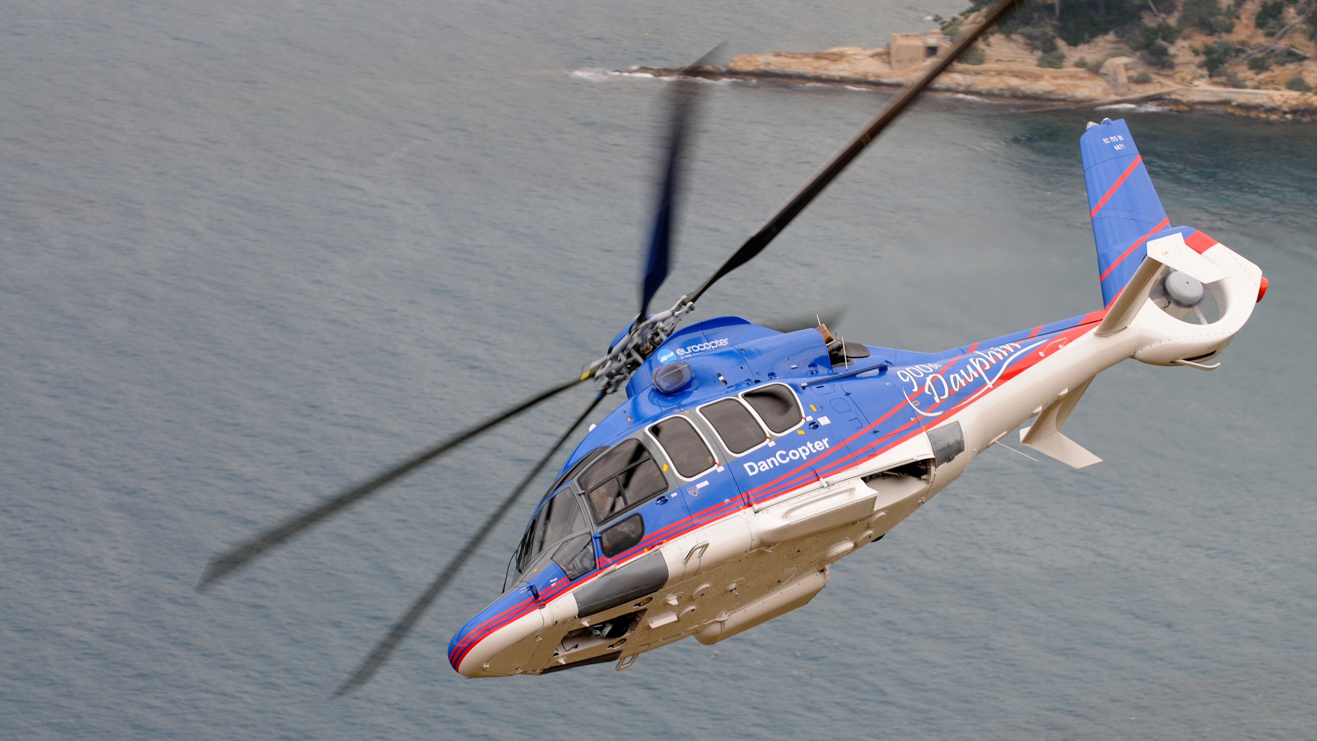 Blue helicopter over water