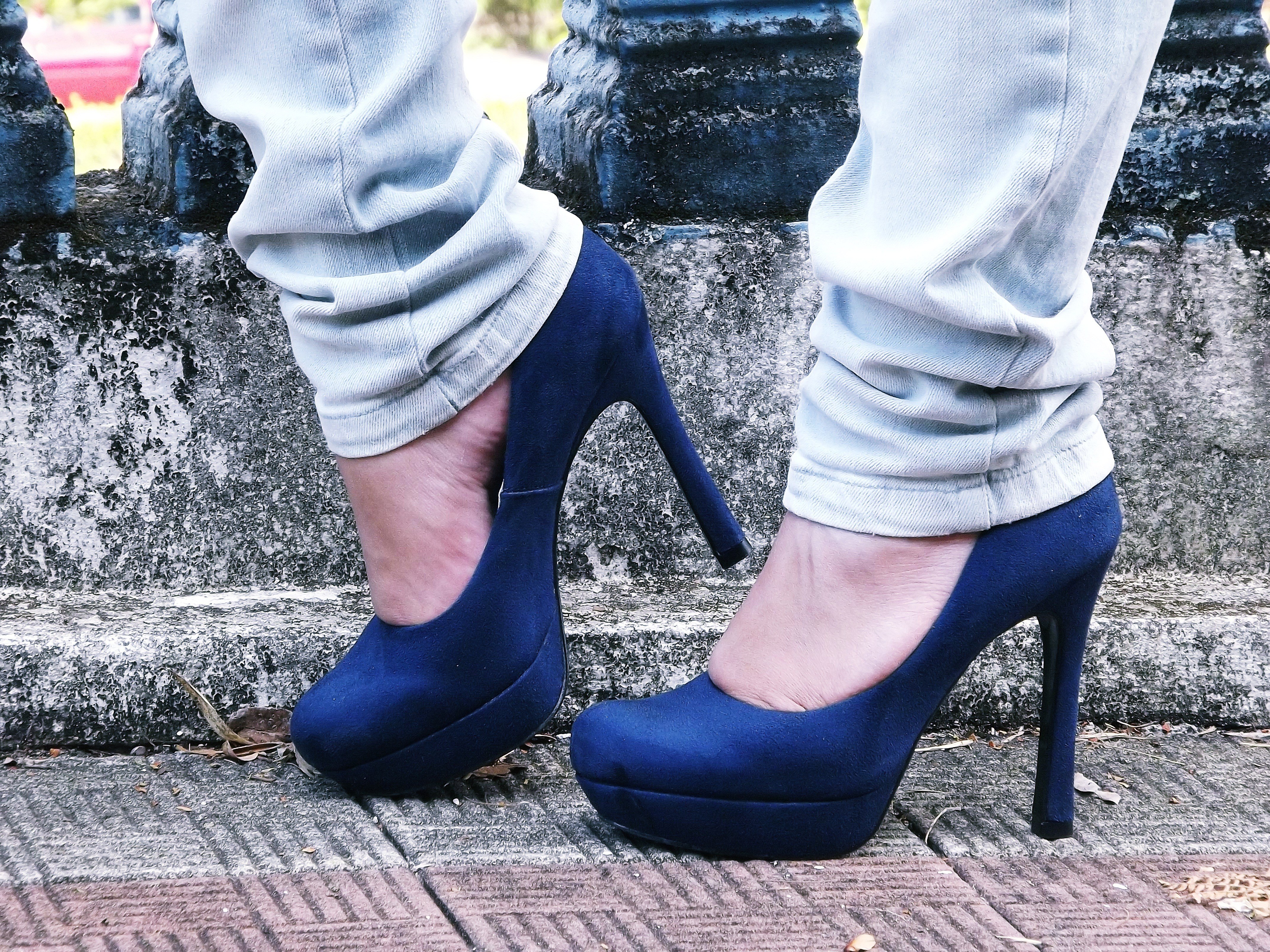 blue high heels on pavement