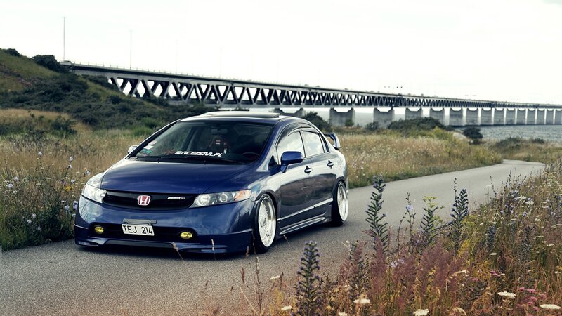 Blue Honda Civic on a coastal road
