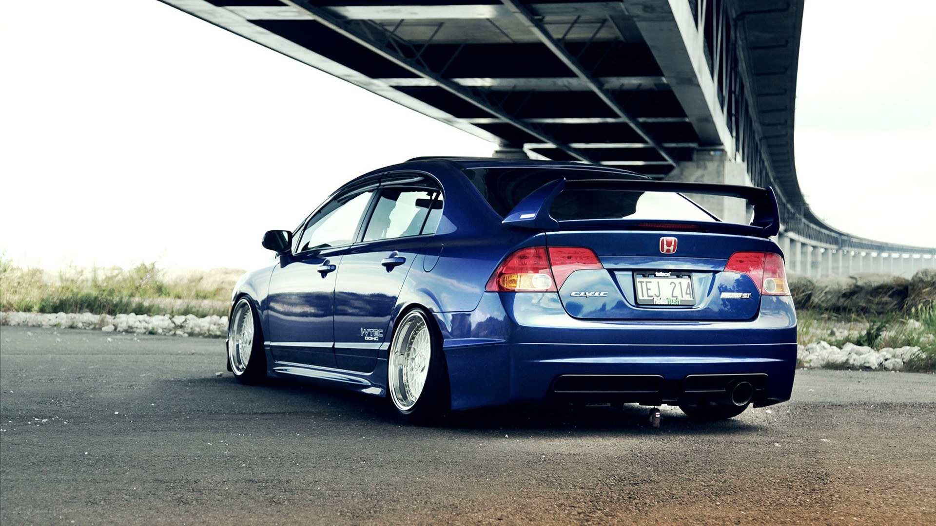 blue honda civic under bridge