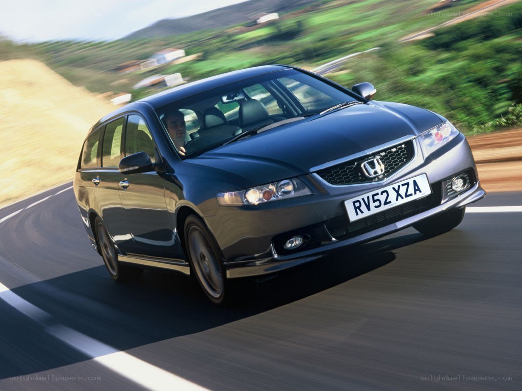 blue honda driving on road