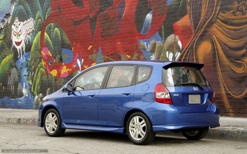 Blue Honda Fit by graffiti wall