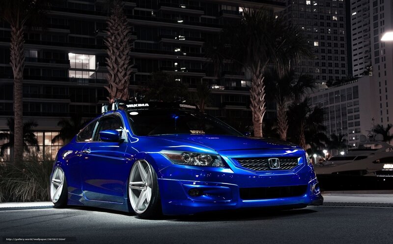 Blue Honda in city at night