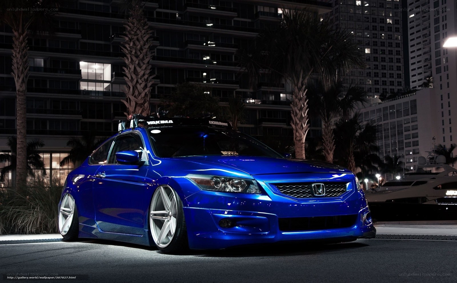 Blue Honda in city at night