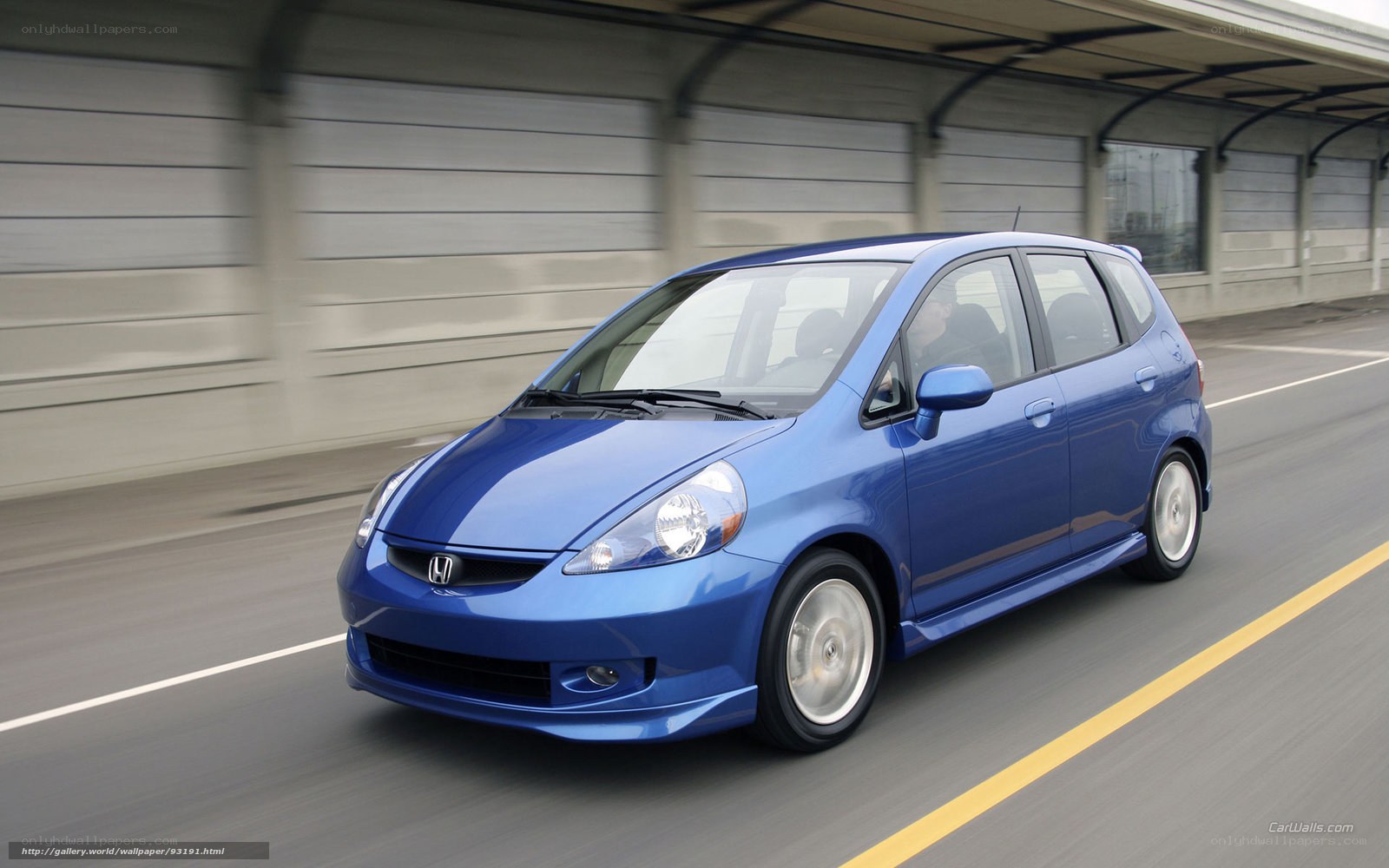 blue honda jazz in motion