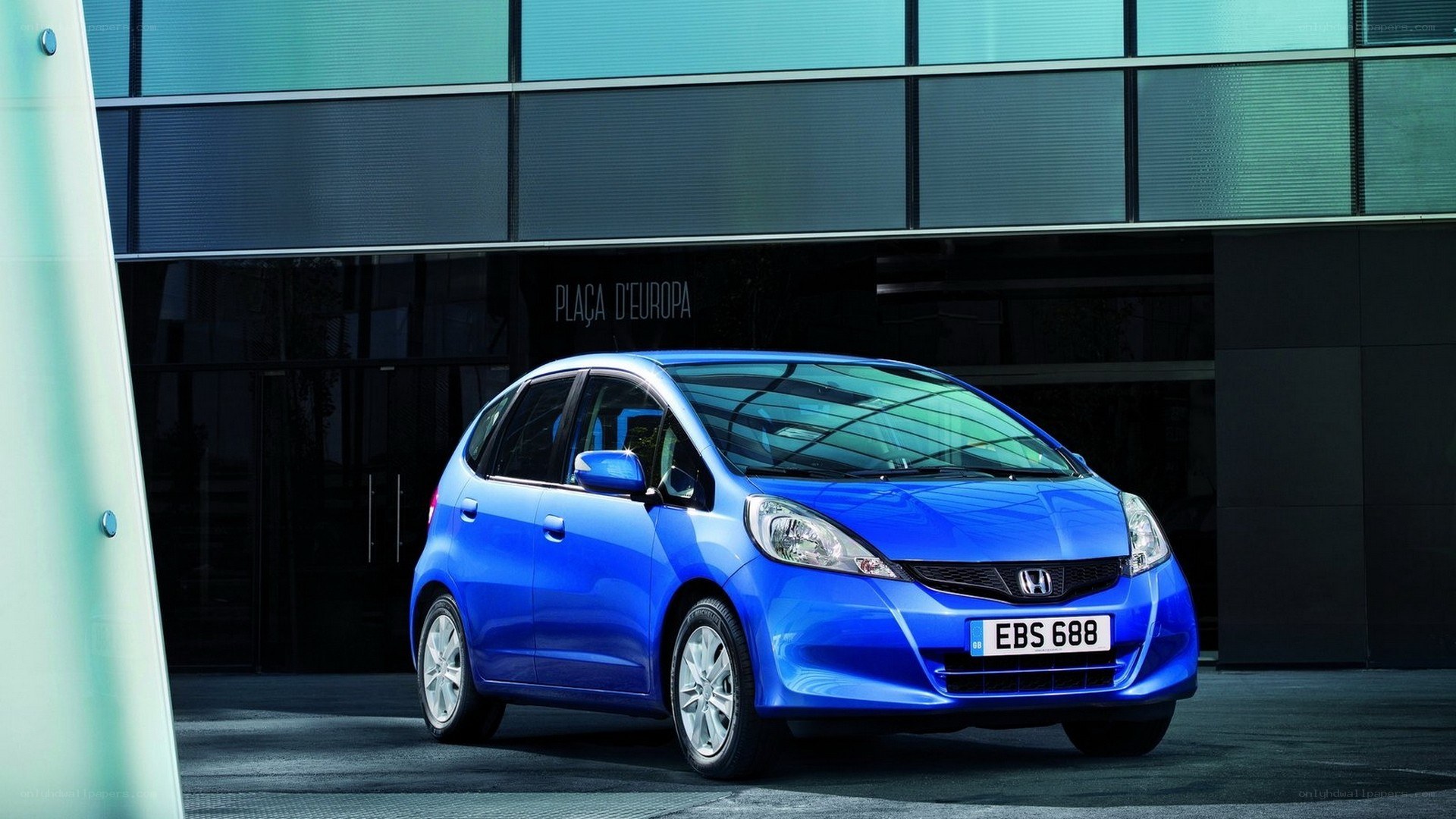 Blue Honda Jazz parked outside