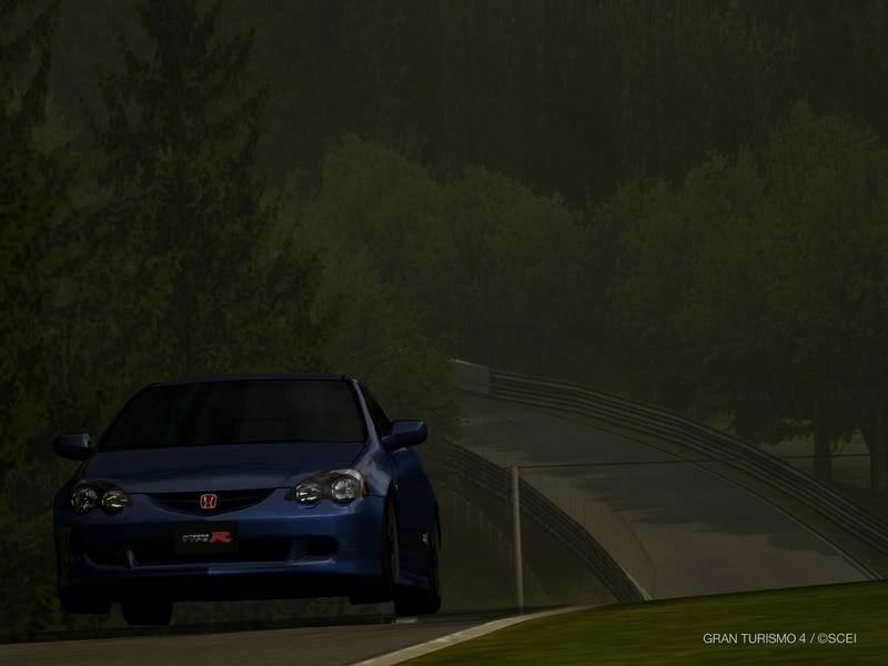 blue honda on a racetrack