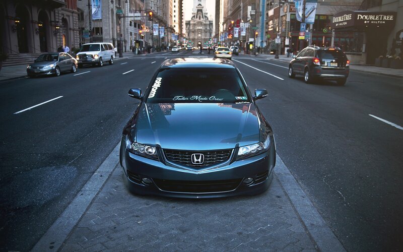 Blue Honda parked on city street