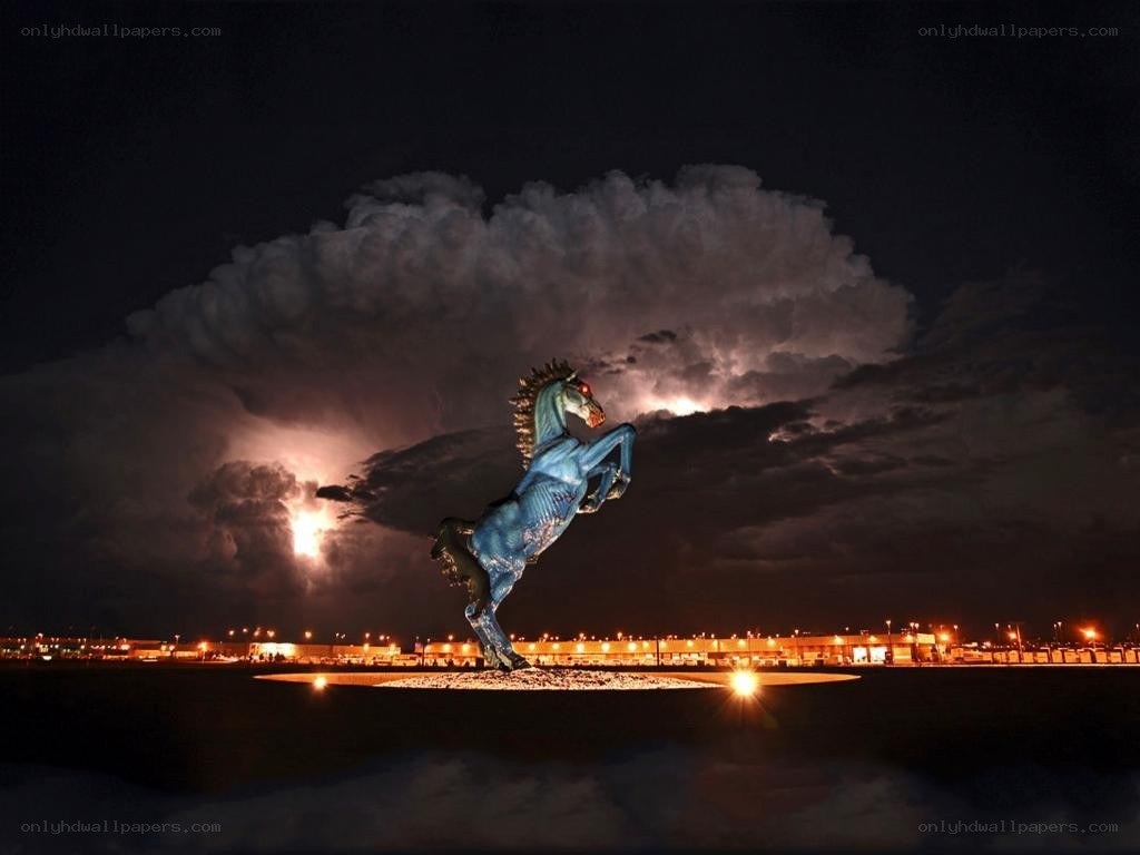 Blue horse statue under stormy sky