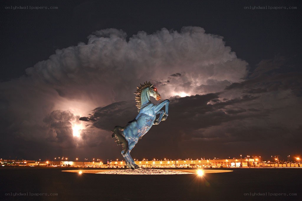 Blue horse statue under stormy sky