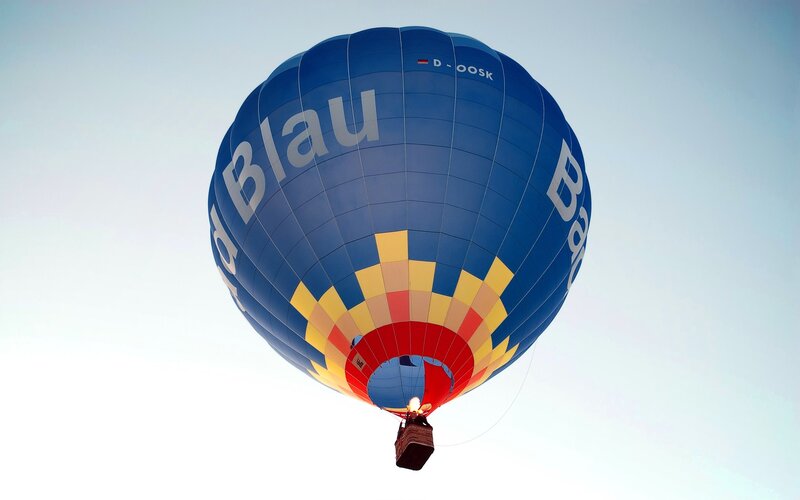 Blue hot air balloon in flight