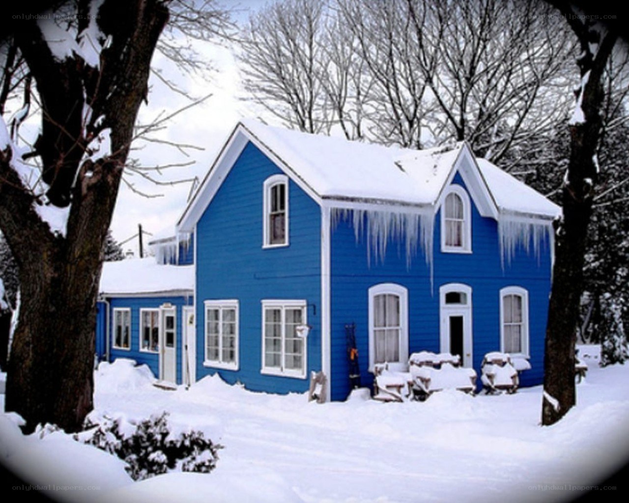 blue house in winter snow