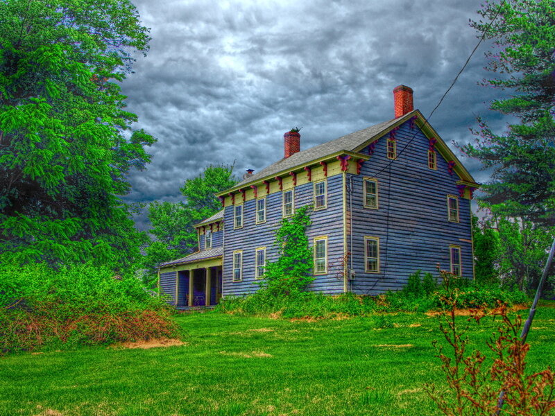 Blue house under stormy sky