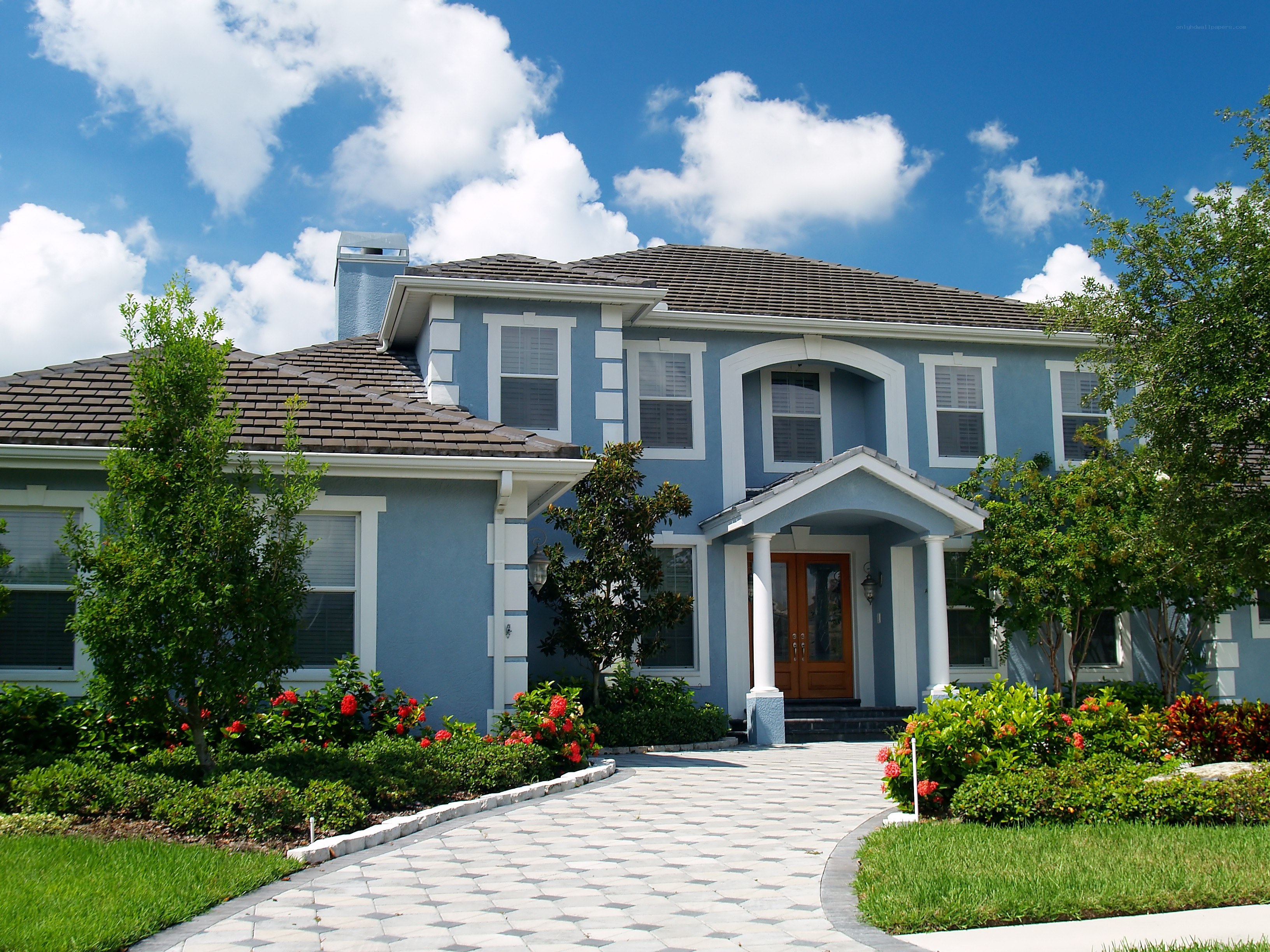 Blue house with tiled driveway