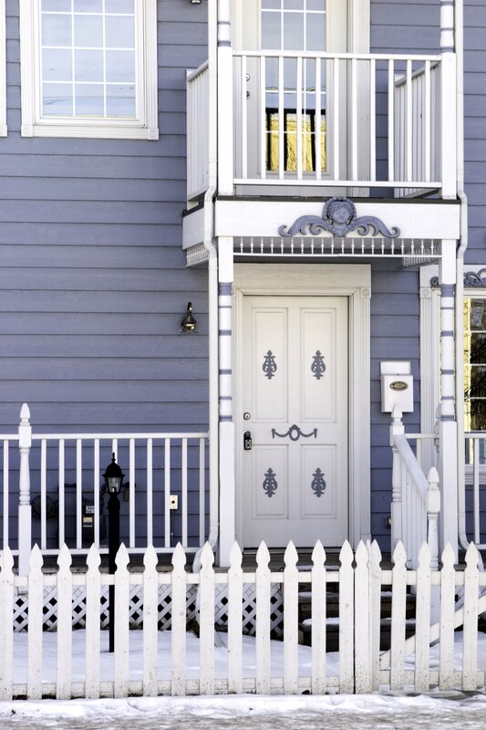 blue house with white picket fence