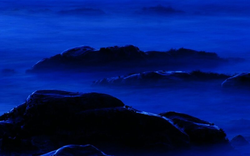Blue-hued rocky coastline