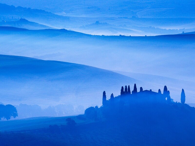 Blue-hued Tuscan hills at dawn