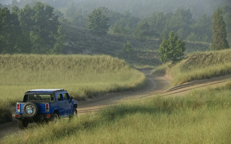 Blue Hummer on a dirt road