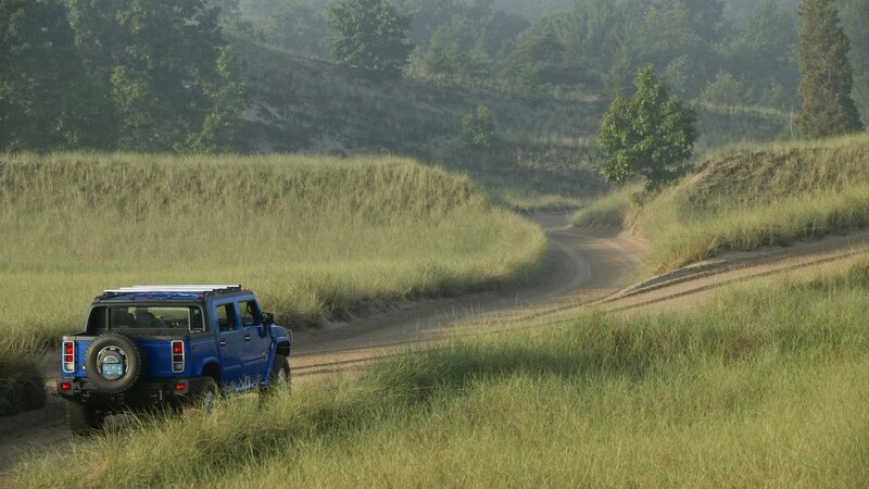 Blue Hummer on a dirt road