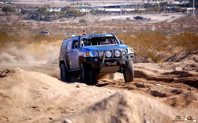 blue hummer racing on dirt