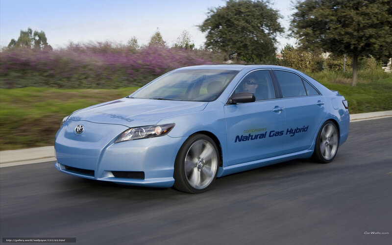 blue hybrid car in motion