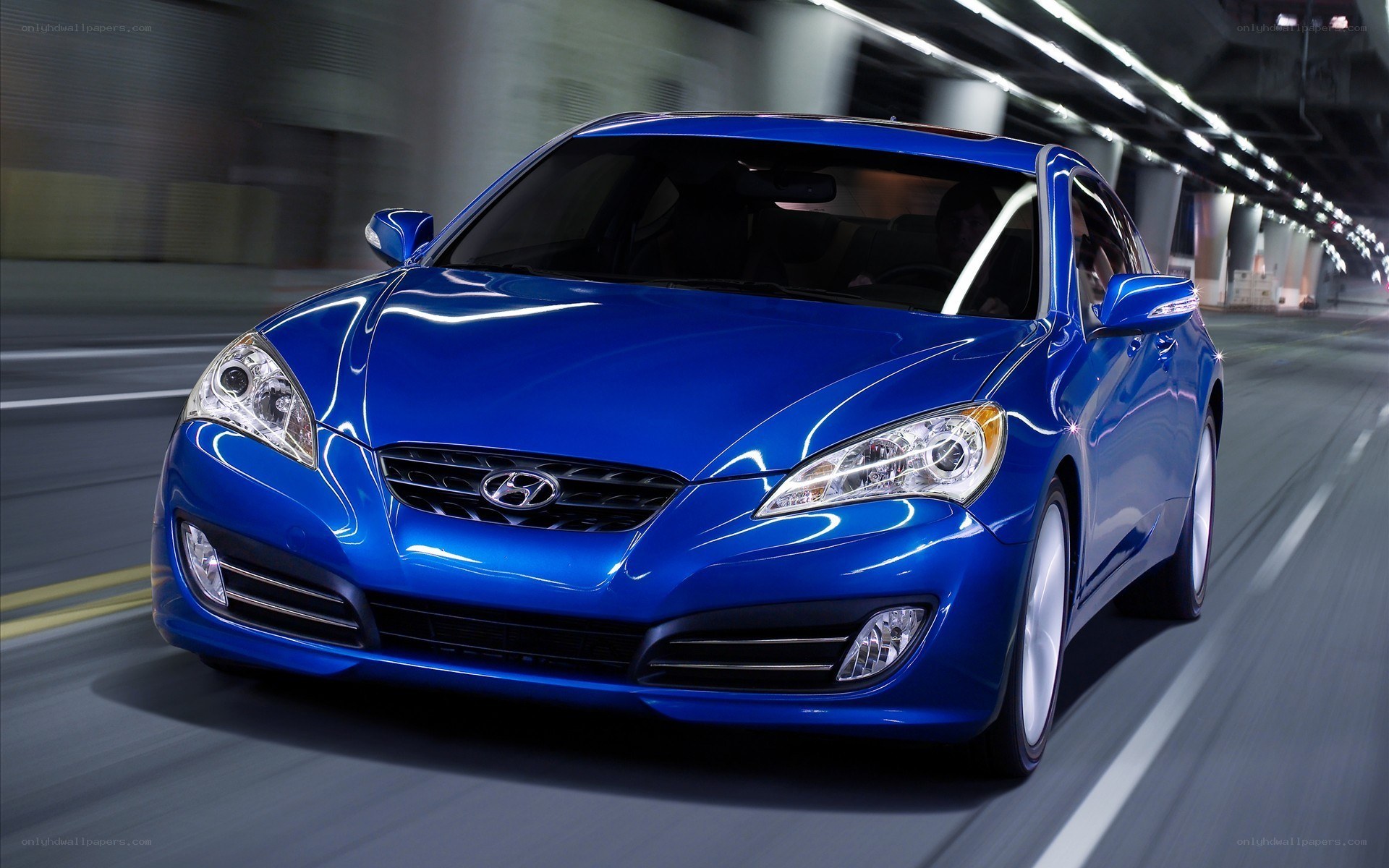 Blue Hyundai Genesis in motion