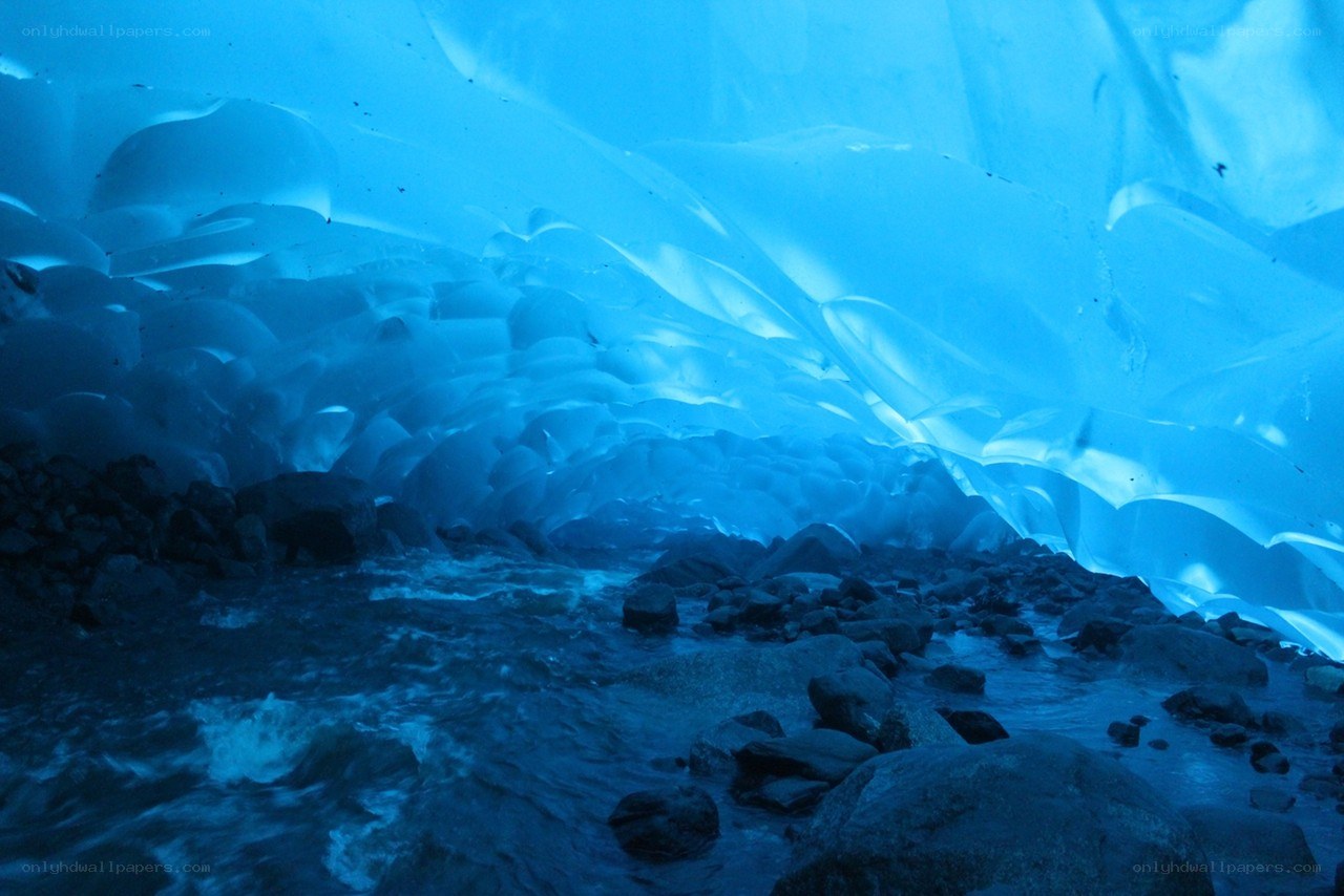 Blue ice cave with stream