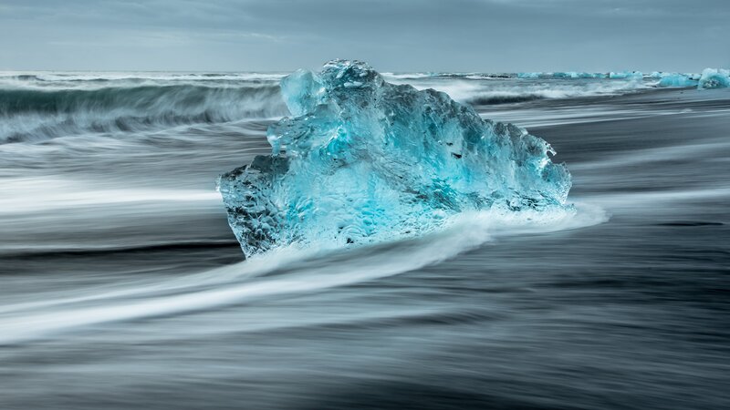 Blue Ice Chunk on Beach — Dramatic, Photograph