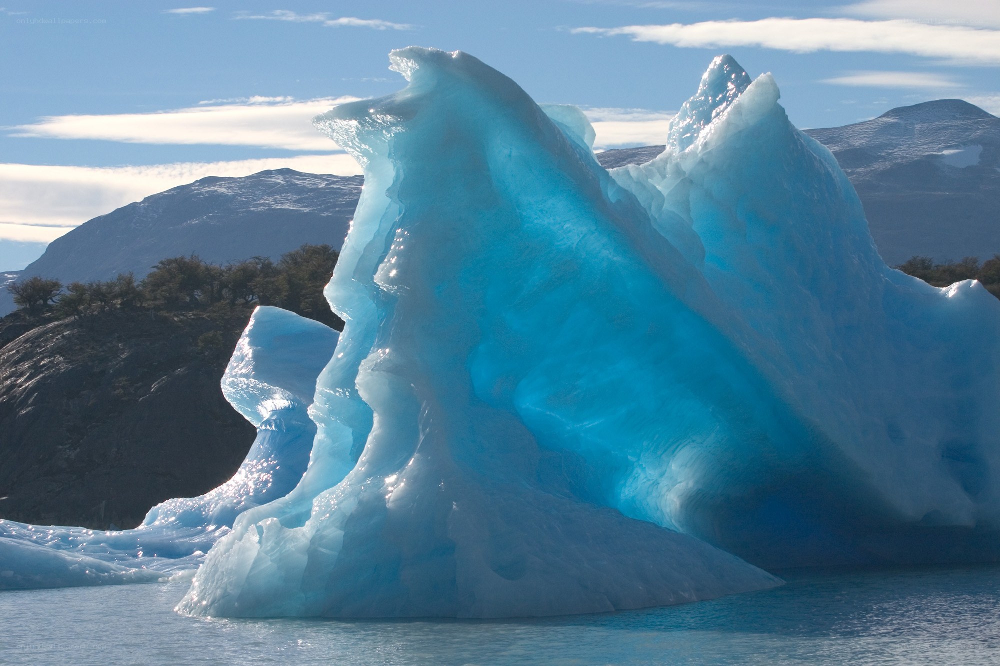 Blue iceberg in calm water