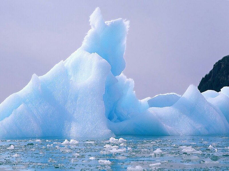 Blue iceberg in icy water