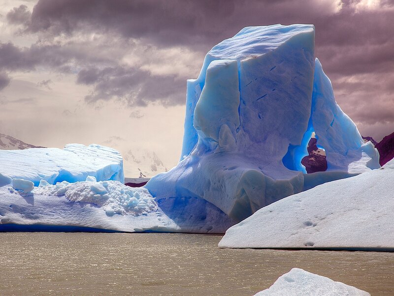Blue Iceberg in Water — Dramatic, Photograph, Clouds
