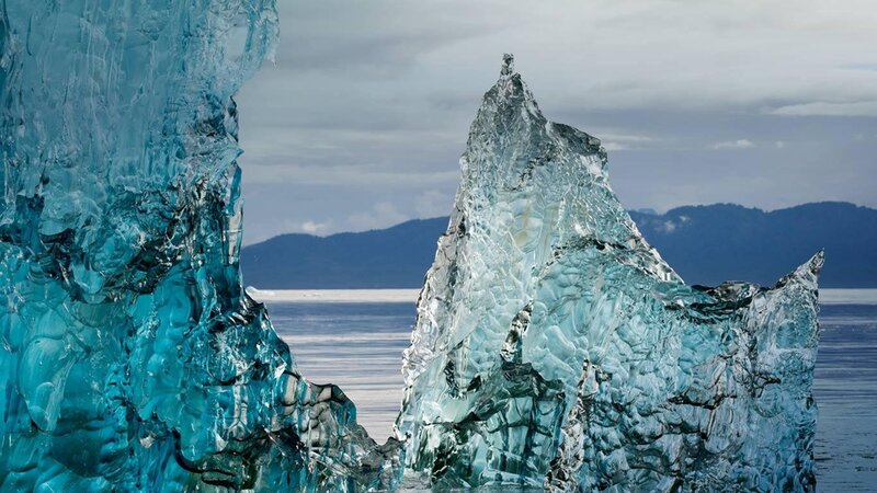 Blue icebergs in calm waters