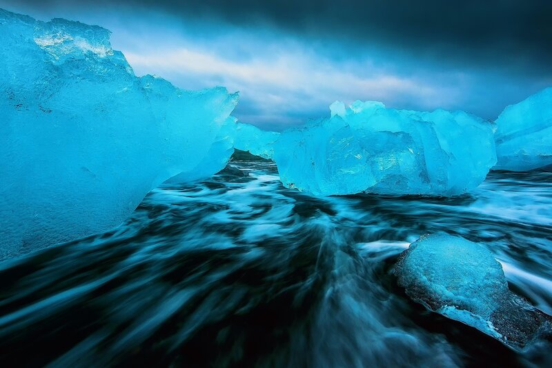 Blue Icebergs in Water — Dramatic