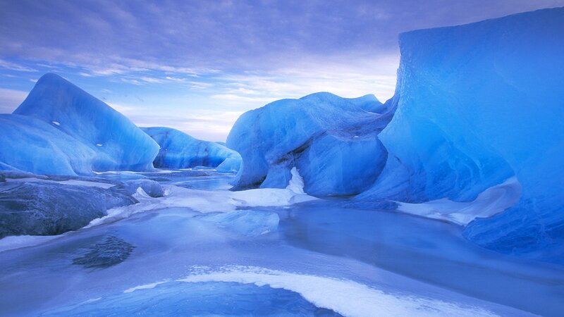 Blue Icebergs in Water — Serene