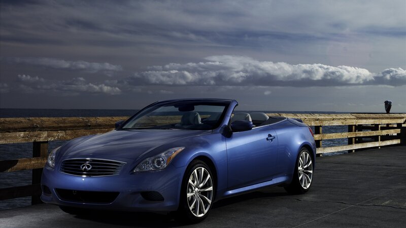 Blue Infiniti convertible on pier