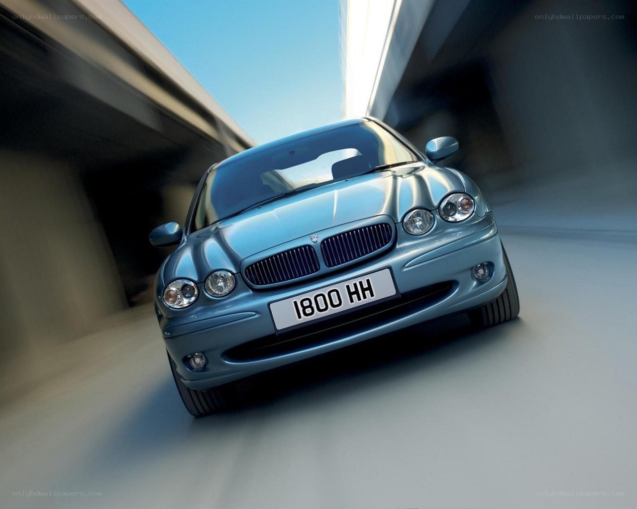 blue jaguar car in motion