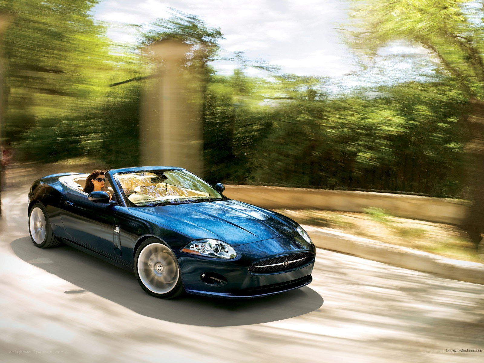blue jaguar convertible driving