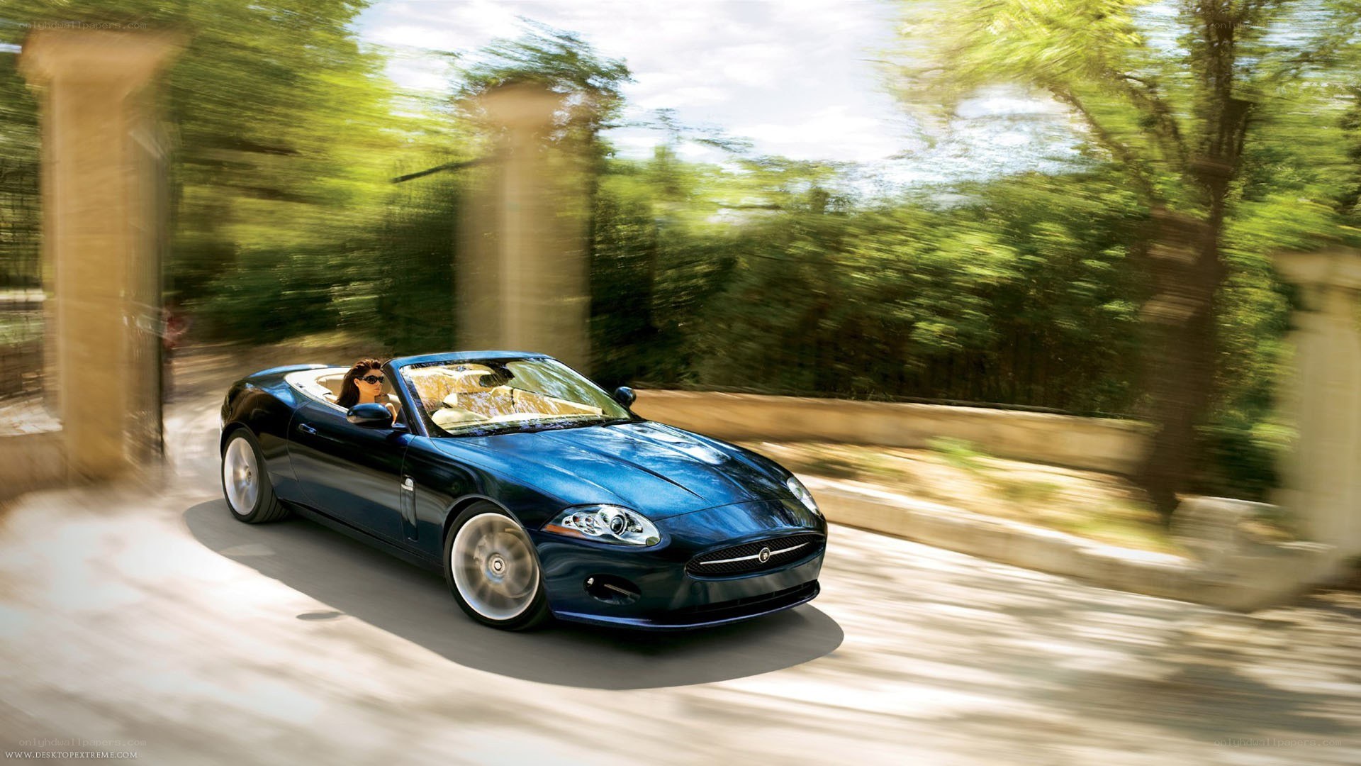blue jaguar convertible driving