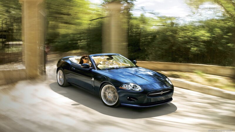 blue jaguar convertible in motion