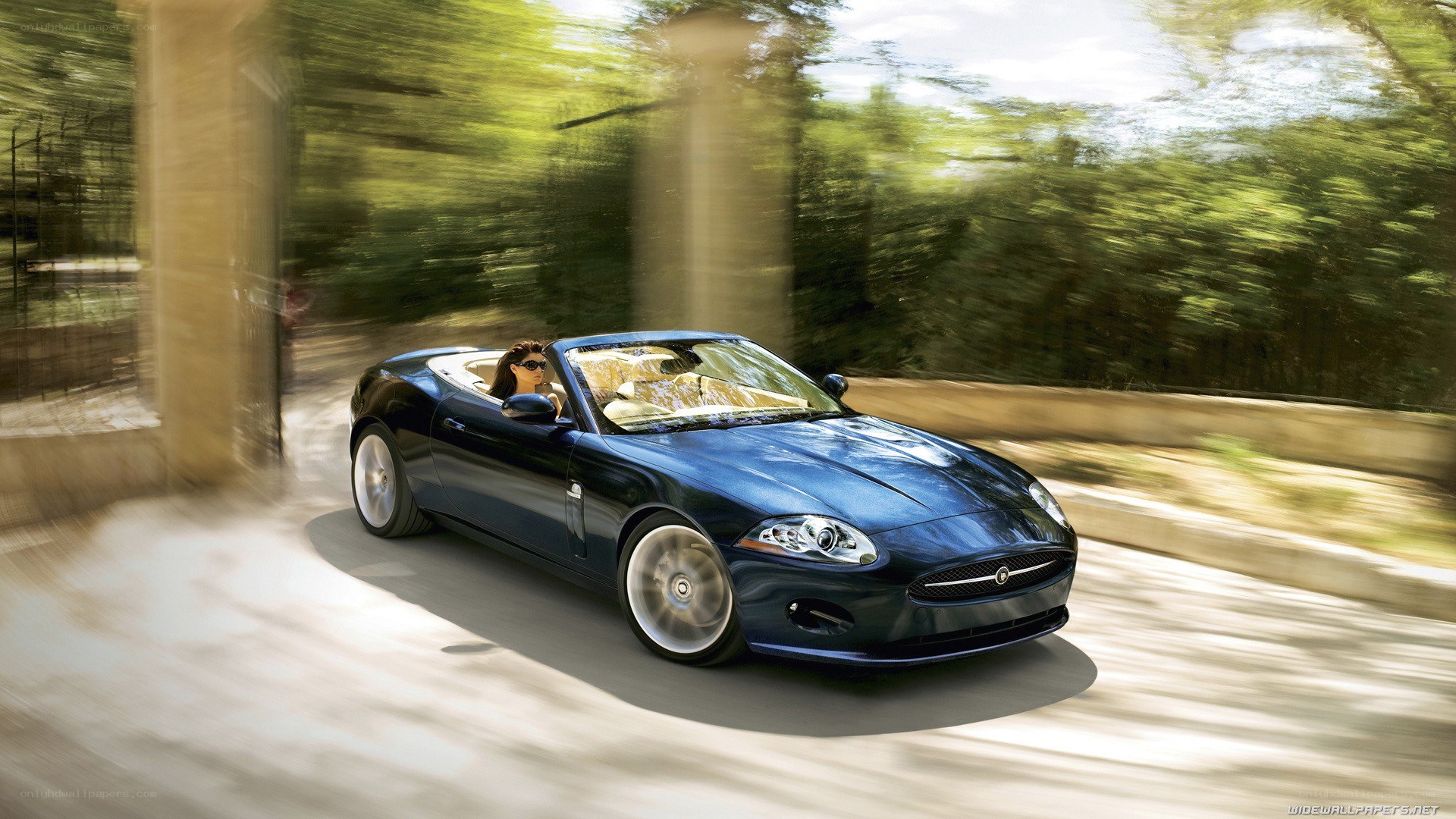 blue jaguar convertible in motion