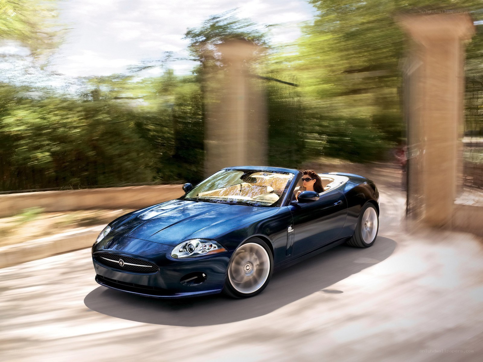 Blue Jaguar convertible in motion