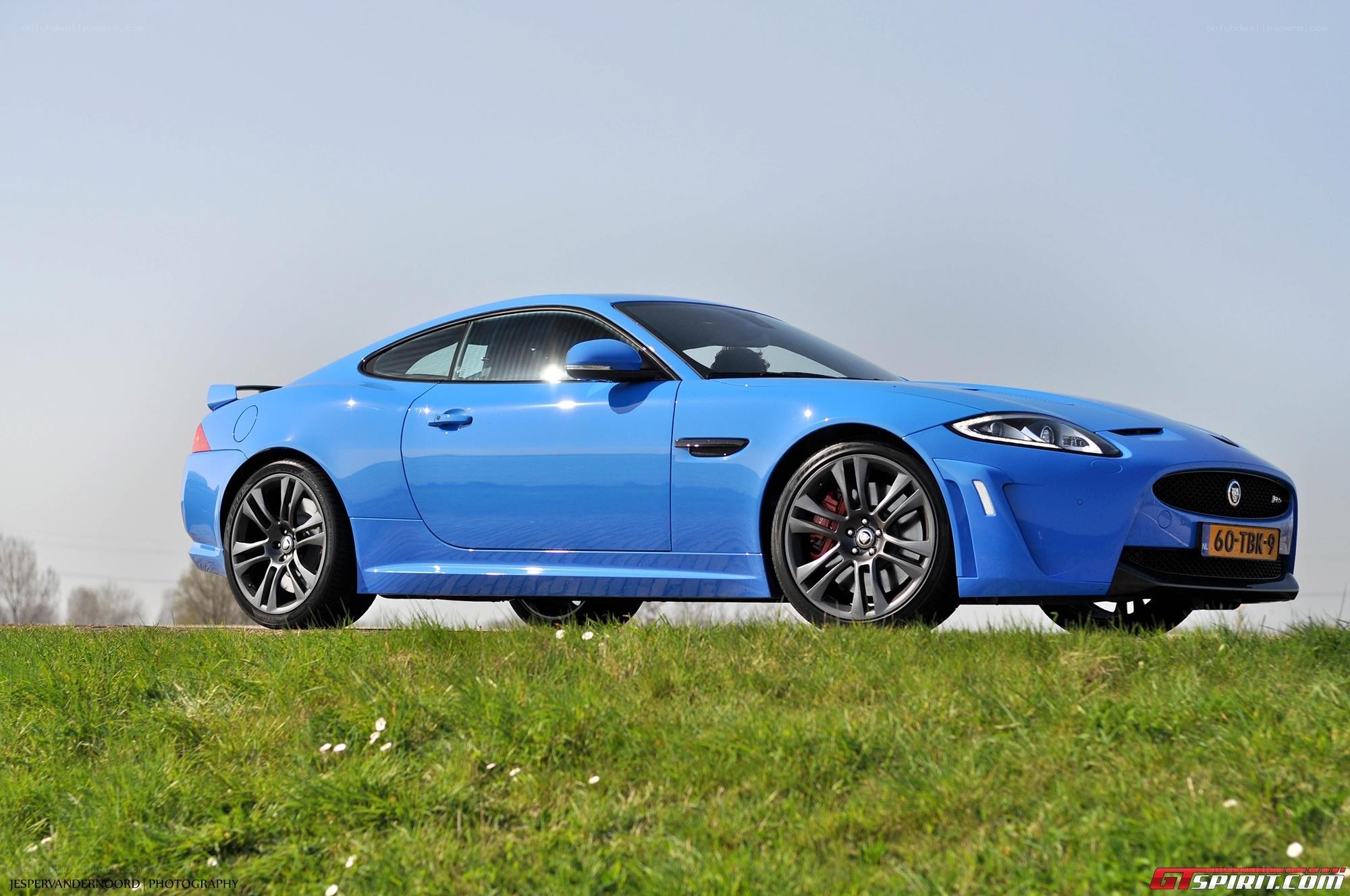 blue jaguar coupe on grass